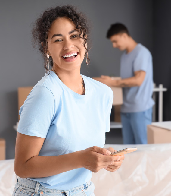 Woman using a smartphone and smiling.