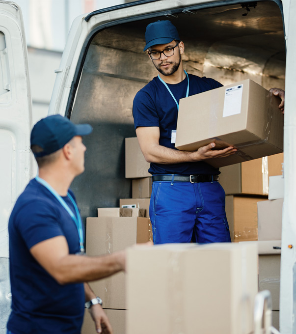 Professional movers loading moving boxes into a moving van.