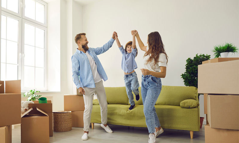 Happy family celebrating their new home after moving.