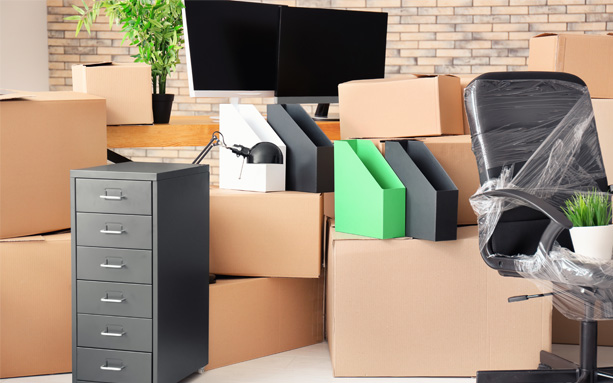 Office furniture and moving boxes in a workspace.