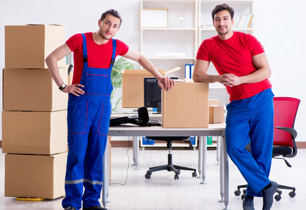 Professional movers standing with moving boxes during an office move.