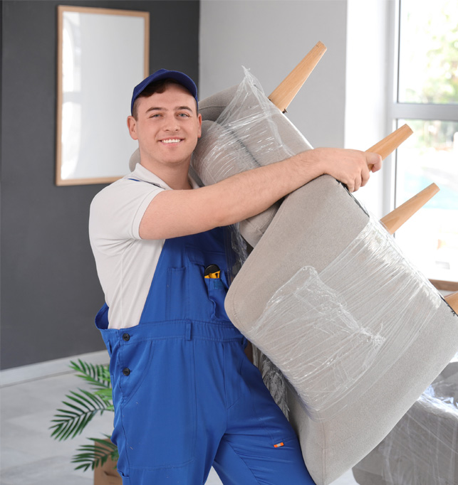Professional mover lifting a sofa inside a home.