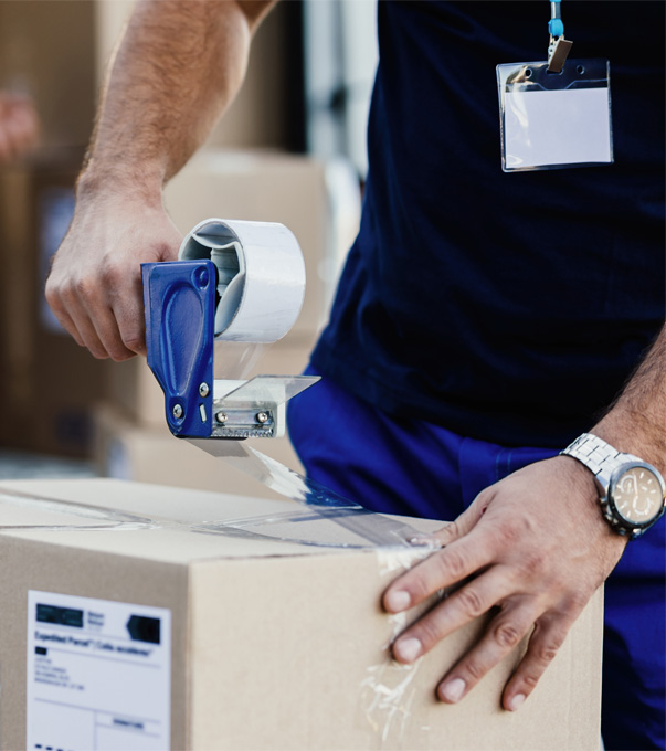 Professional mover holding a packing tape dispenser.