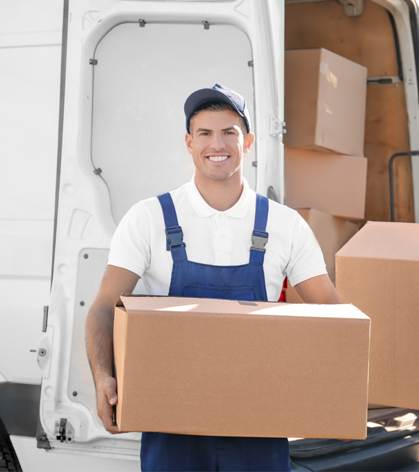Professional mover holding a moving box beside a van.